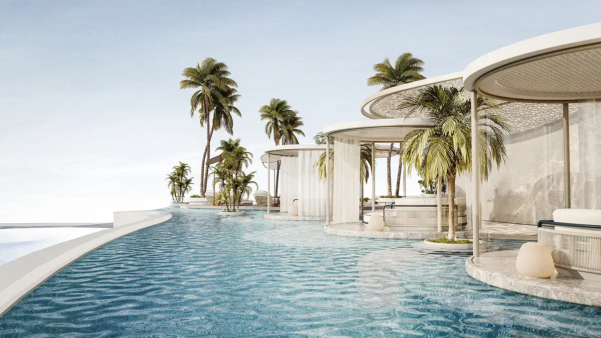 A serene lagoon-style pool surrounded by palm trees and private cabanas floating above the water.