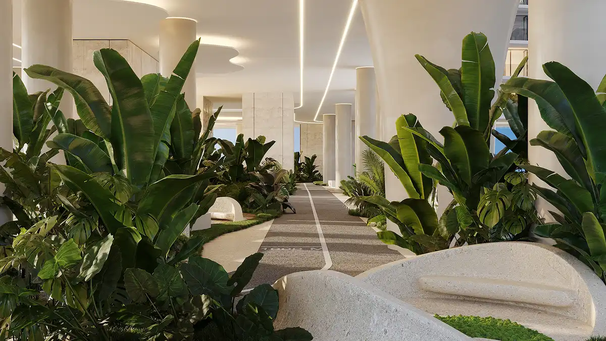 A peaceful shaded walkway lined with vibrant tropical plants and elegant architectural curves.