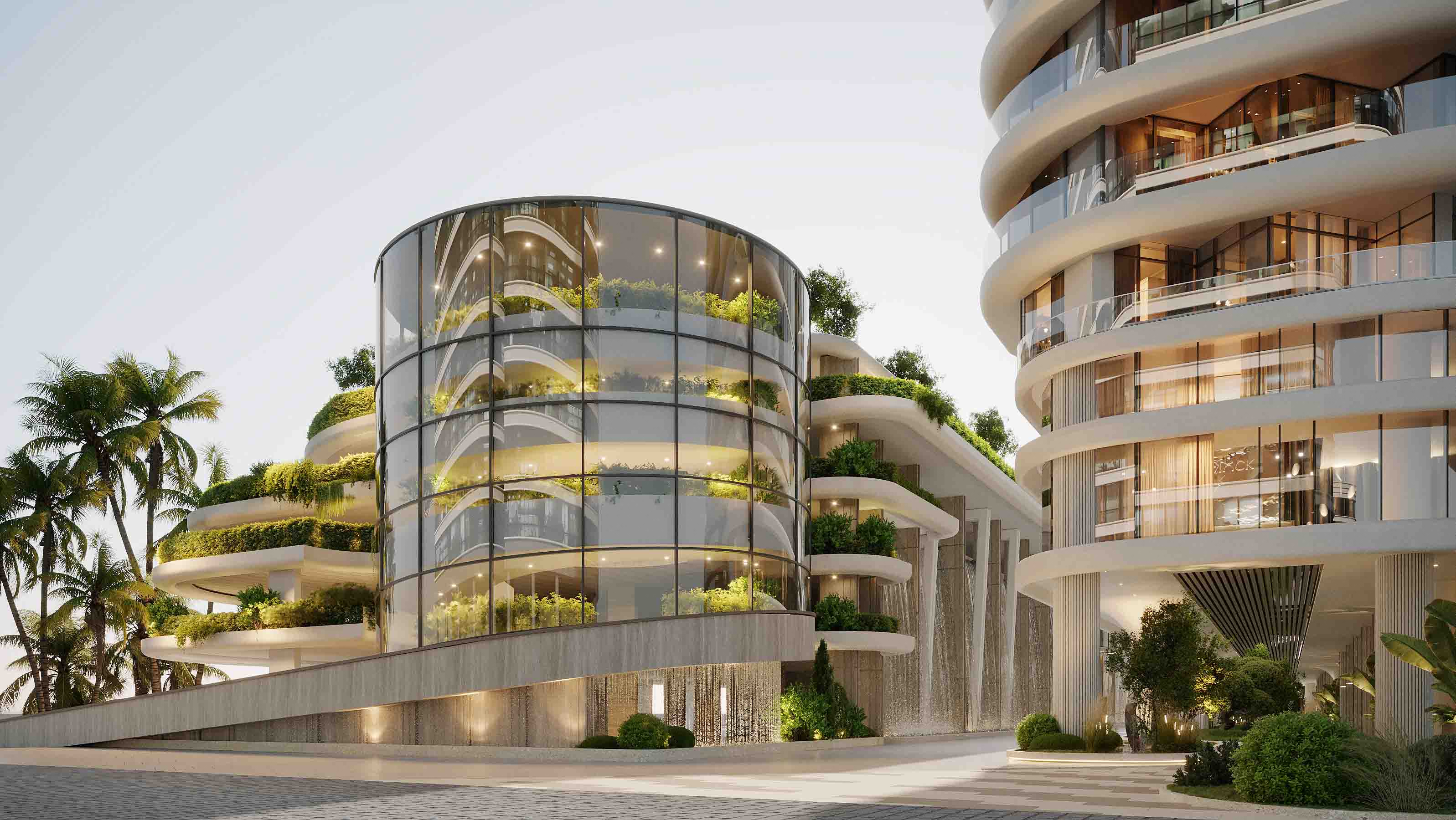 Daytime view of the glass pavilion rising above cascading greenery and water features.