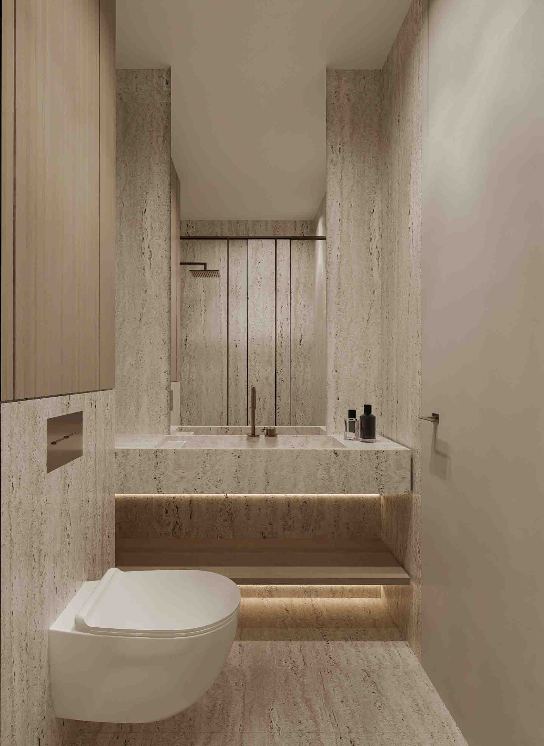 Compact bathroom with floating toilet, stone walls and illuminated vanity shelf.