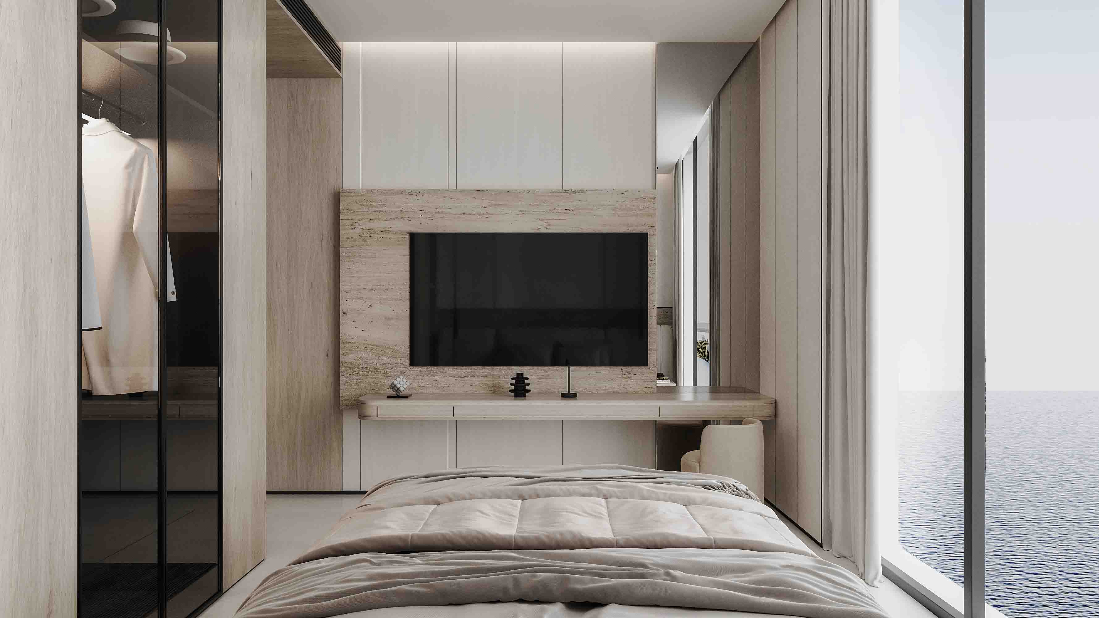 Bedroom with built-in desk, stone TV wall and uninterrupted sea view through floor-to-ceiling glass.