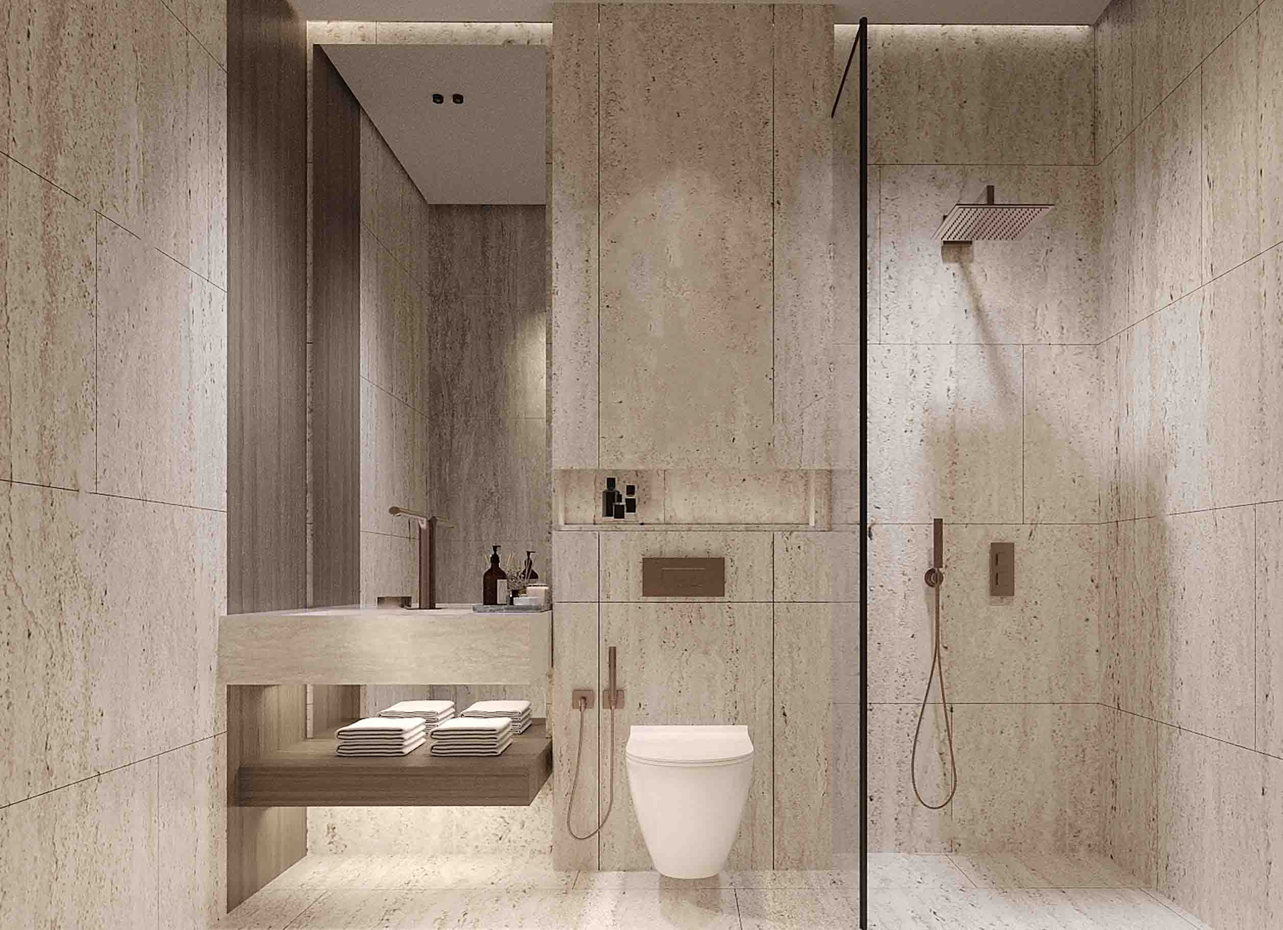 Serene bathroom with travertine walls, walk-in shower and floating vanity with neatly stacked towels.