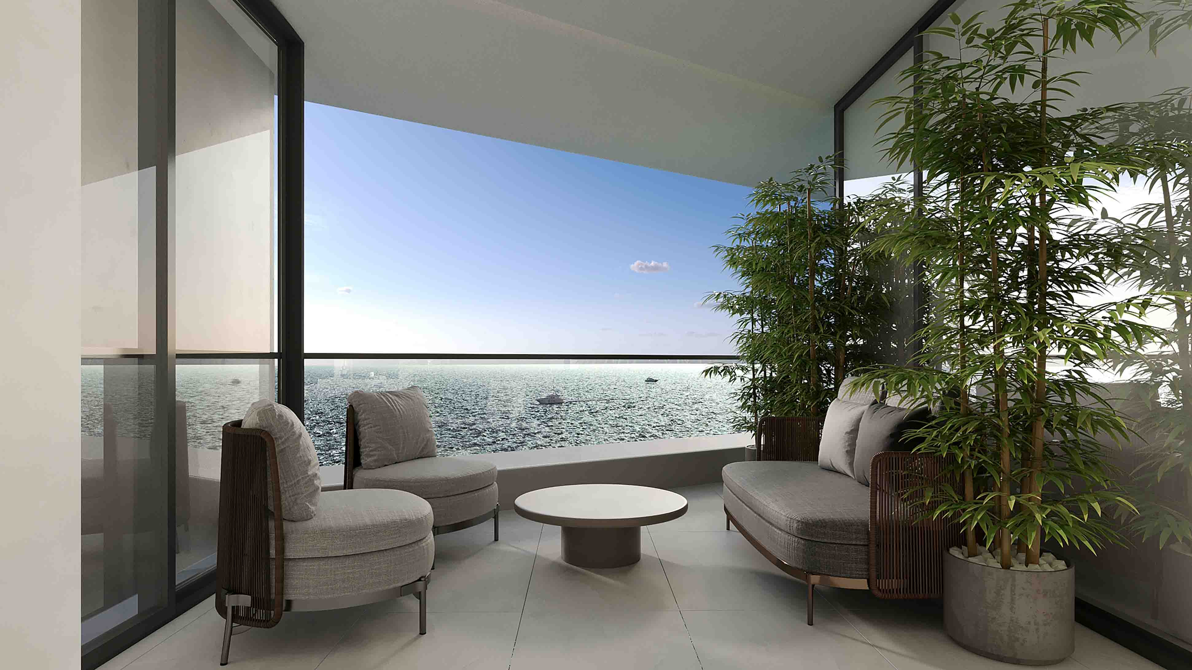 Cozy balcony lounge with contemporary armchairs, low table and panoramic sea views framed by lush greenery.