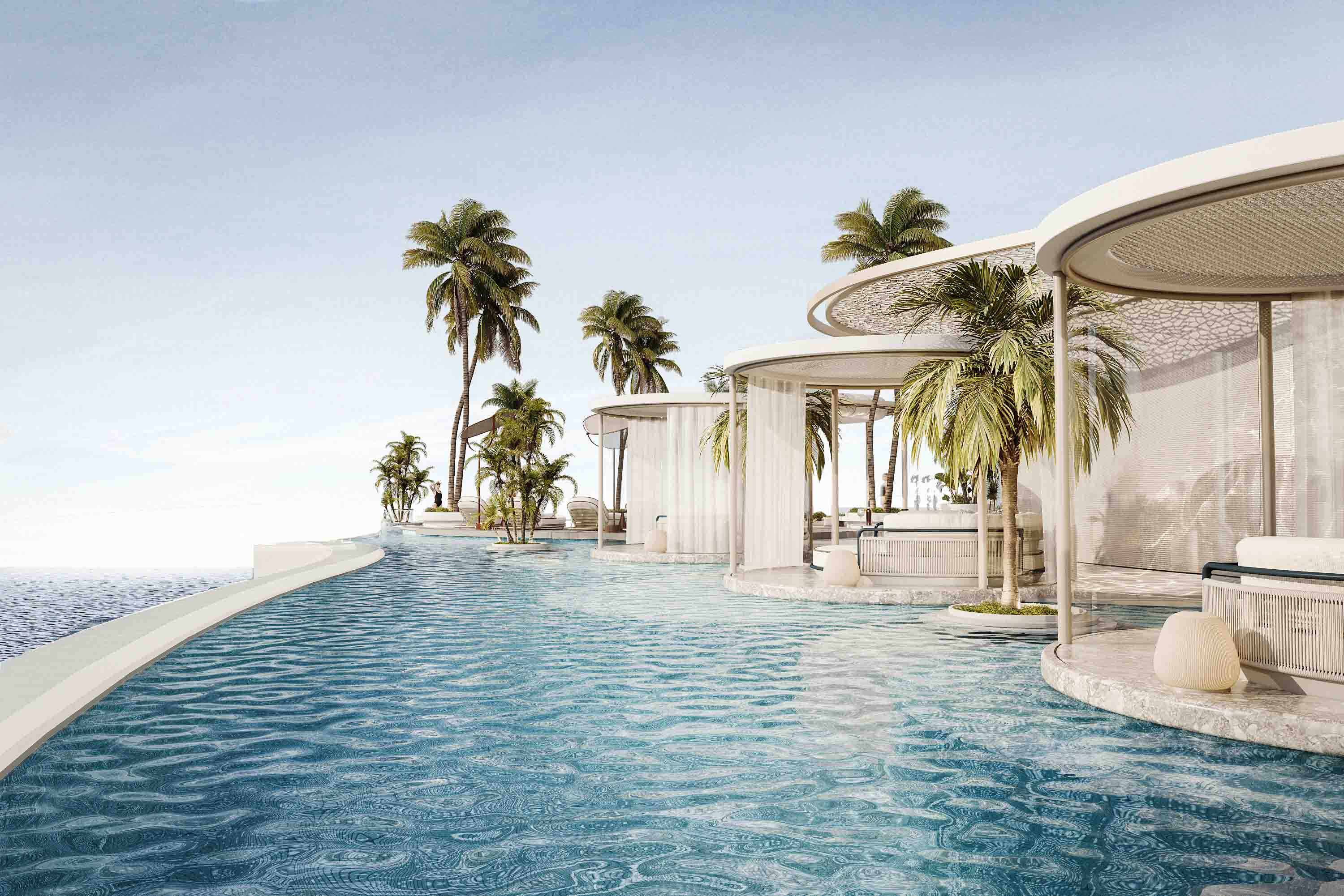 Expansive rooftop lagoon pool lined with sculptural cabanas and palm clusters facing the ocean.